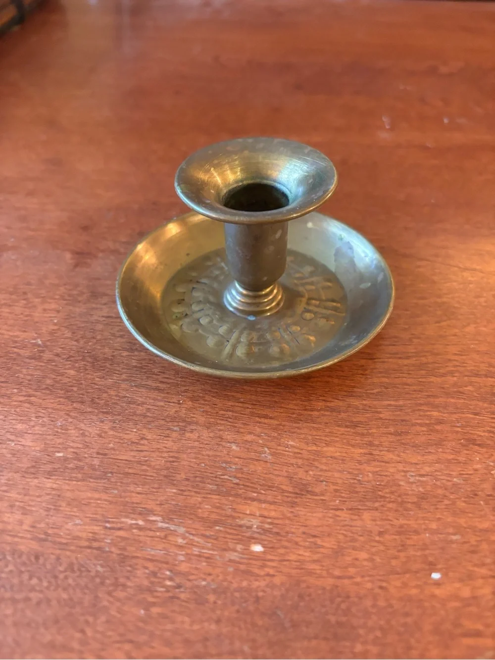 vintage brass chamberstick candle holder with a circular base and a ring handle
